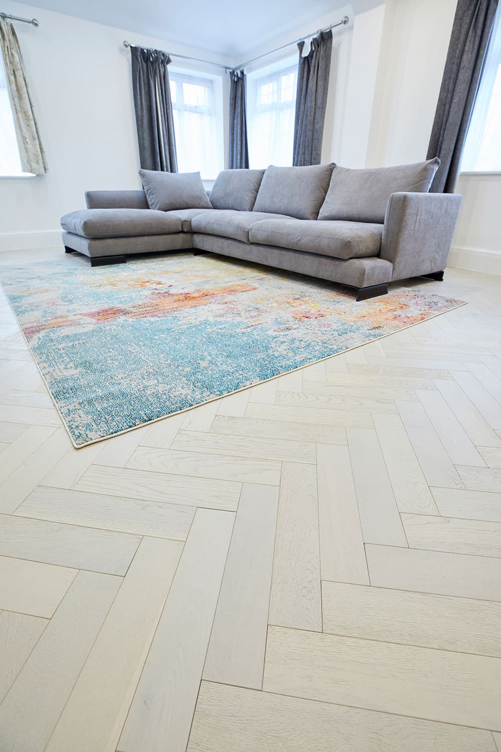 white oak flooring in living room with rug