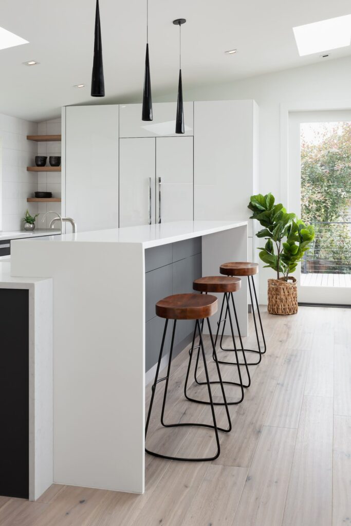 Modern kitchen with greige hardwood flooring