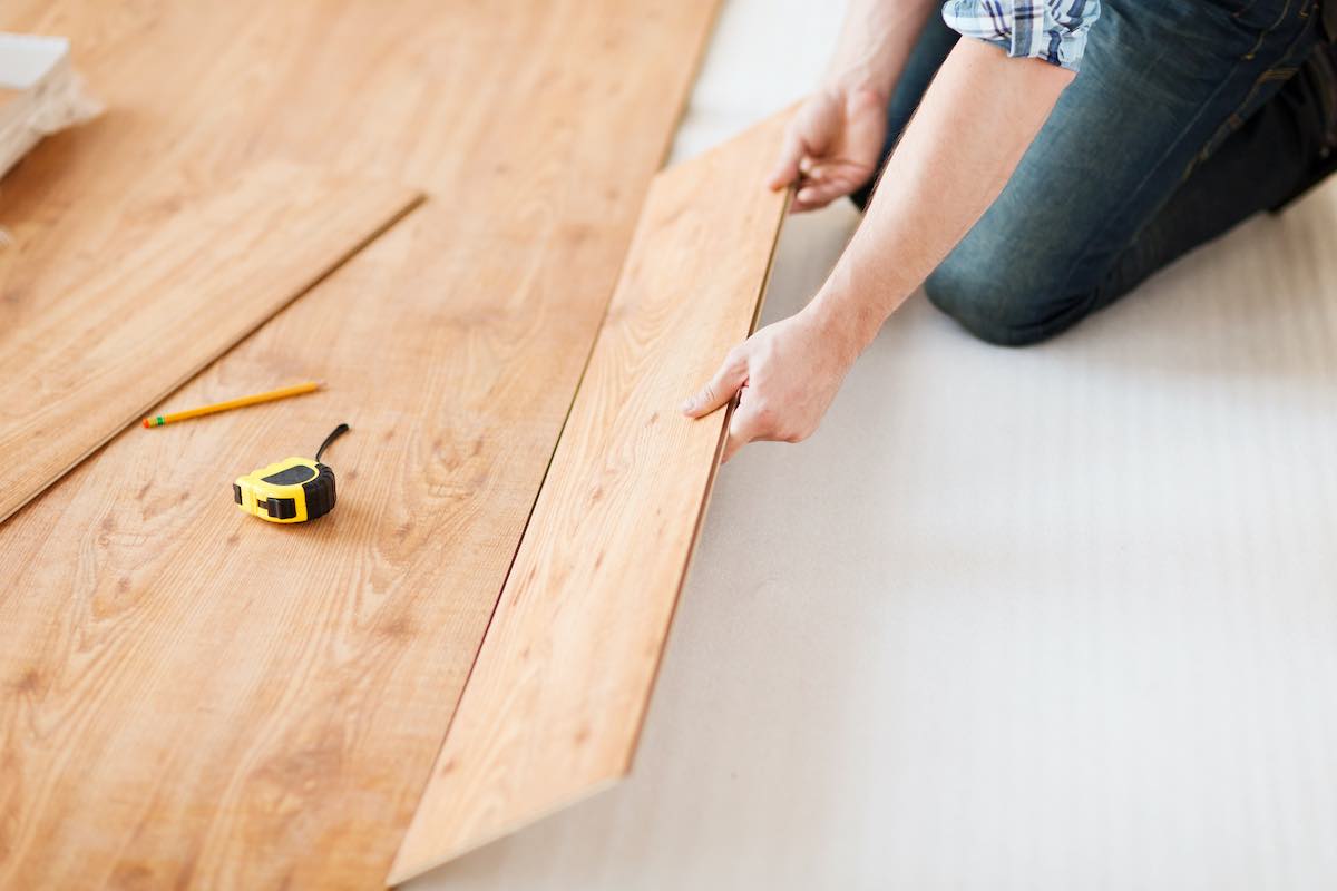 man installing wood flooring