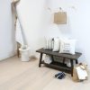 Coastal entry with wood bench and engineered hardwood flooring in white tones